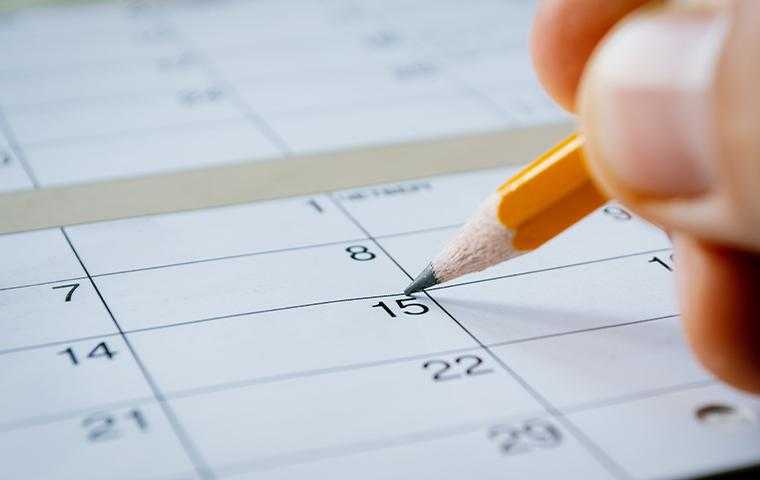 person marking a date on a calendar in tucson arizona