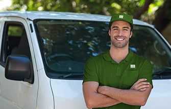 a technician in front of a company van in tucson arizona